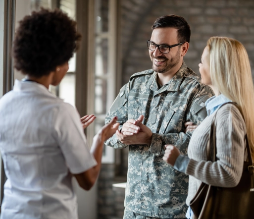 happy army soldier and his wife communicating with healthcare worker